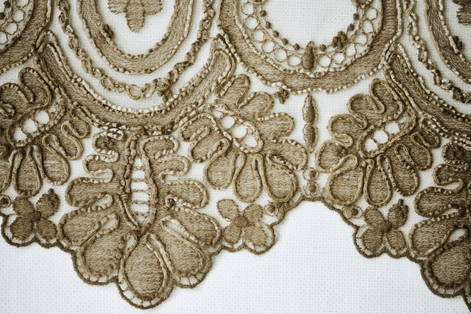 A detailed golden-brown lace border on white