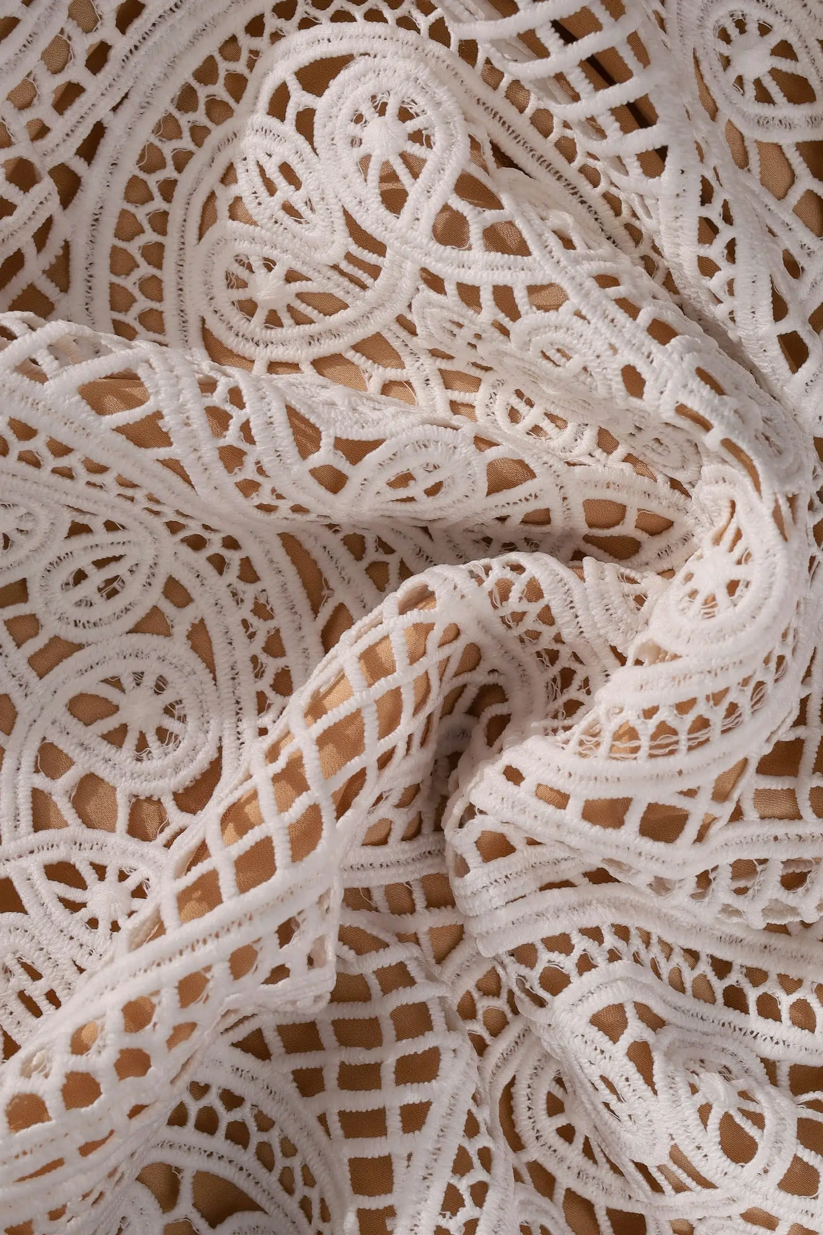 Close-up of white lace with swirling patterns